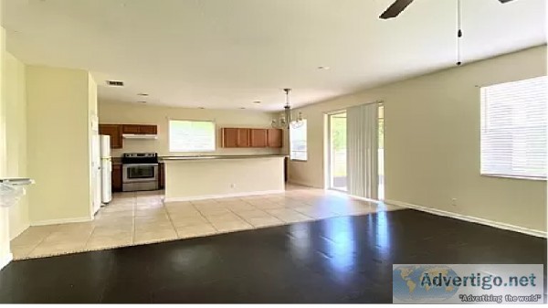 family room with laminate wood floor and plush new carpets in be