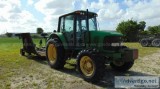 2003 John Deere 6420 tractor with a mowing attachment