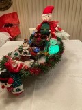 Big elf in sleigh with santa stocking holder and goodies