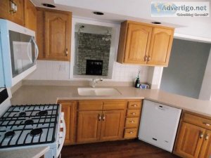 Kitchen Cabinets In Oak With Appliances And Corian Counter Tops