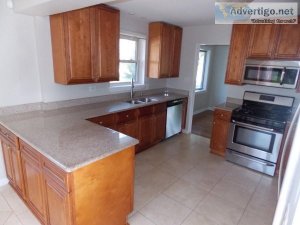 Cherry Kitchen With Granite Counters And Appliances